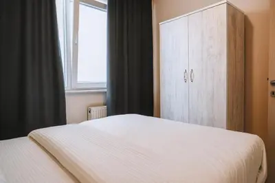a bedroom with a bed and a cabinet and a window at PARADİSE pansiyon otel in Nilüfer