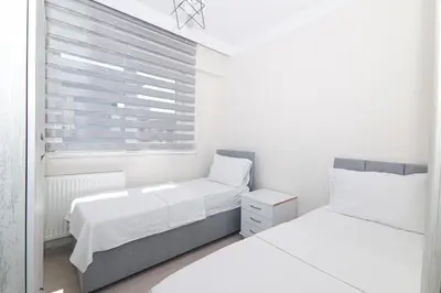 a bedroom with two beds and a window at PARADİSE pansiyon otel in Nilüfer