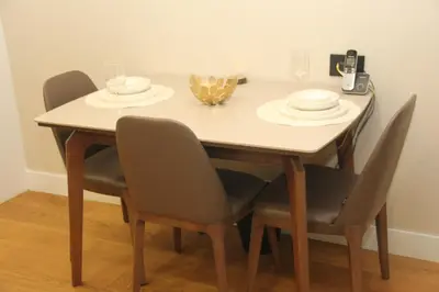 a table with chairs and plates and glasses on it at Lovely One Bedroom Appartment-530 in Istanbul