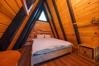 a bedroom with a bed in a wooden cabin at MC Sapanca Hotel in Sakarya