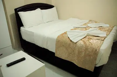 a bedroom with a bed with a black headboard at Tolga Hotel in Istanbul