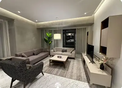 a living room with a couch and a tv at Enjoy luxury family apt in Istanbul