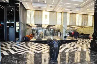 a lobby with a large black and white patterned floor at Cozy luxury apt in Sinpas queen in Istanbul