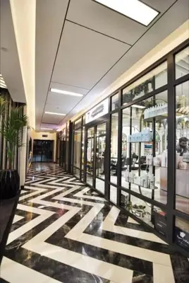 a shopping mall hallway with a black and white floor at Cozy luxury apt in Sinpas queen in Istanbul