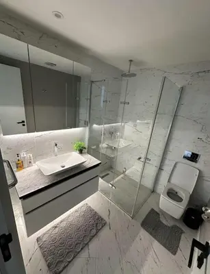 a bathroom with a sink and a shower and a toilet at Elegant 2 bedroom apt Sinpas queen gym pools in Istanbul