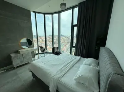 a bedroom with a bed and a large window at Elegant 2 bedroom apt Sinpas queen gym pools in Istanbul