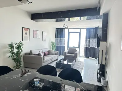 a living room with a couch and a table and chairs at Luxury apt in the 40 plus floor in Istanbul