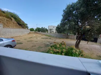 a car parked in a yard next to a wall at Kadıoğlu Pansiyon in Ormanlı