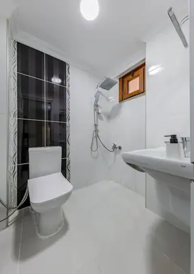 a white bathroom with a toilet and a sink at Fatih'te yeni 3 odalı Daire No 1 in Istanbul
