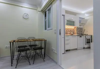 a kitchen with a table and chairs in a room at Fatih'te yeni 3 odalı Daire No 1 in Istanbul