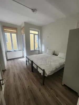 a bedroom with a bed in a room with wooden floors at Nostalgia Apartment in Istanbul