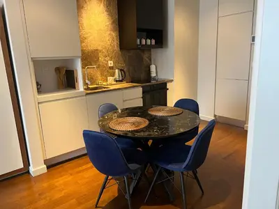 a kitchen with a black table and blue chairs at ultra lüxs in Istanbul