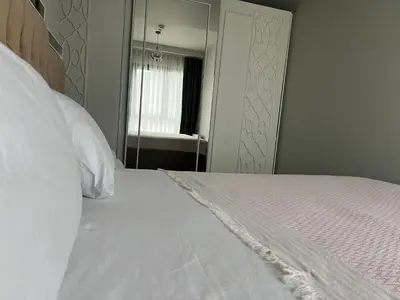 a bedroom with a white bed and a mirror at ultra lüxs in Istanbul
