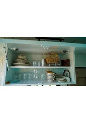 a kitchen counter with plates and dishes on a shelf at HUZURLU BİR TATİl - CARAVAN SERENITY in Domalı