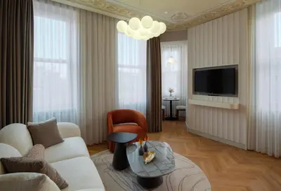 a living room with a couch and a tv at Casa Foscolo Hotel, Istanbul, a Member of Design Hotels in Istanbul