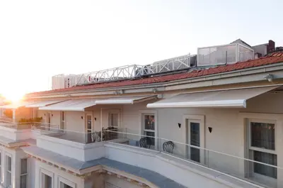 a building with a balcony with a train on top of it at Casa Foscolo Hotel, Istanbul, a Member of Design Hotels in Istanbul