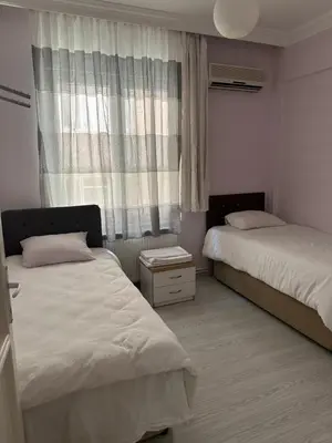 a bedroom with two beds and a window at Bursa central house in Bursa