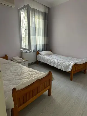 a bedroom with two beds and a window at Bursa central house in Bursa