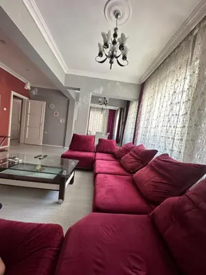 a large living room with a large red couch at Bursa central house in Bursa