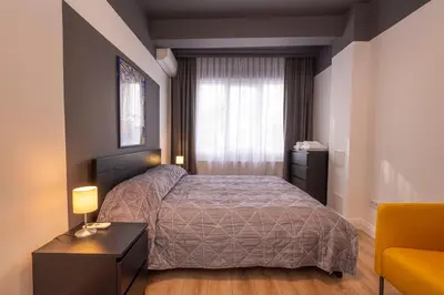 a small bedroom with a bed and a window at Hip Waterfront Apt with a Striking View in Istanbul