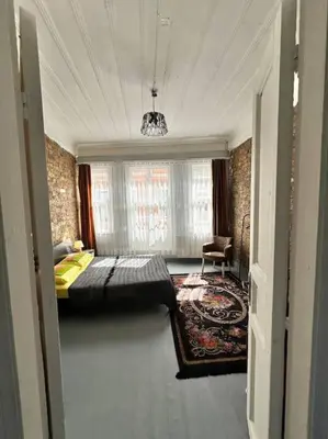 a bedroom with a bed and a chair in a room at Yildirim's Home in Istanbul