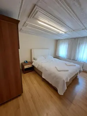 a bedroom with a large bed and a wooden floor at Tumer House Sultanahmet in Istanbul