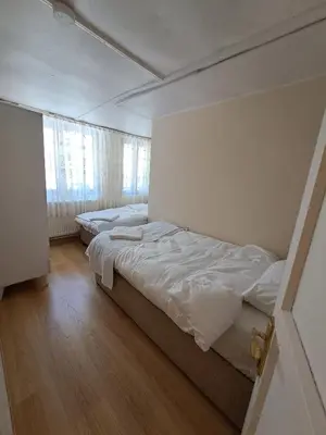 two beds in a small room with wooden floors at Tumer House Sultanahmet in Istanbul