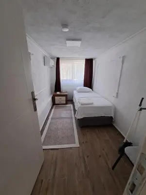 a small room with two beds and a window at Tumer House Sultanahmet in Istanbul