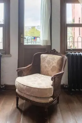 a chair in a room with a window and a radiator at Balat luxury House With Sea View in Istanbul