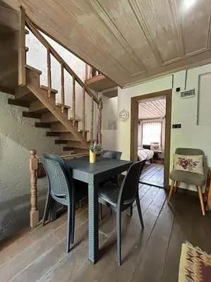 a dining room with a table and chairs and stairs at Balat luxury House With Sea View in Istanbul