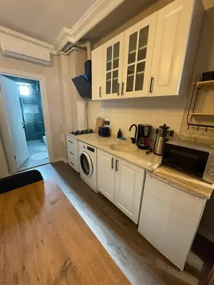 a kitchen with white cabinets and a sink at Golden Arrow Taksim 1 in Istanbul