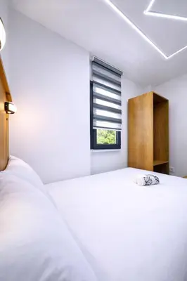 a white bedroom with a bed and a window at Kilic Boutique Hotel in Istanbul