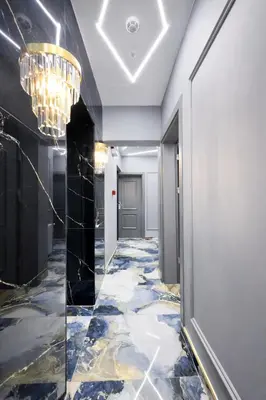 a hallway with a marble floor and a chandelier at Kilic Boutique Hotel in Istanbul