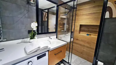 a bathroom with a white sink and a shower at Excellent Apartments Fatih Legacy in Istanbul