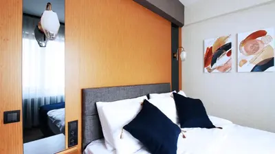 a bedroom with a bed with a wooden headboard at Excellent Apartments Fatih Legacy in Istanbul