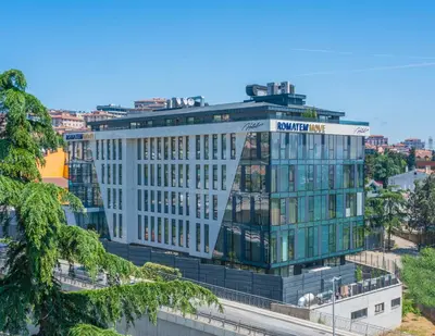 a tall white building with a sign on it at Romatem Move İstanbul Disabled Hotel in Istanbul