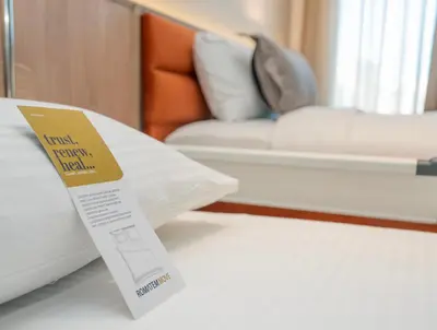 a sign on a table next to a bed at Romatem Move İstanbul Disabled Hotel in Istanbul