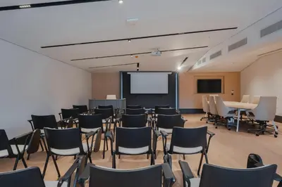 an empty room with chairs and a projection screen at Romatem Move İstanbul Disabled Hotel in Istanbul