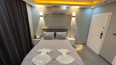 a bedroom with a bed with two towels on it at Cevas Suite Hotel in Istanbul