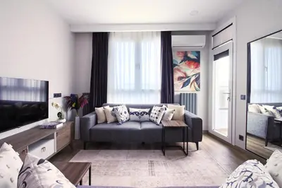 a living room with a couch and a tv at Excellent Apartments Fatih Golden Horn in Istanbul