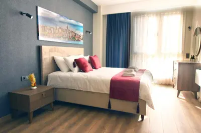a bedroom with a large bed with red pillows at Excellent Apartments Fatih Golden Horn in Istanbul