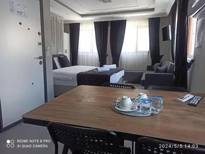 a room with a dining table and a living room at Özdemir Apart - Sultanahmet in Istanbul