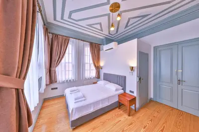 a bedroom with a bed and a coffered ceiling at Va Mansion in Istanbul