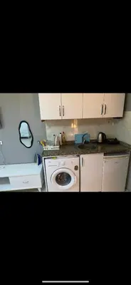 a kitchen with a sink and a washing machine at Cosy studio apartment in Istiklal central in Istanbul