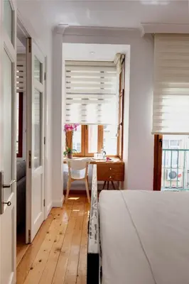 a bedroom with a bed and a dining room with a table at Bomonti Residence charming flat in Istanbul