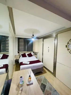 a hotel room with two beds and a table at Taksim Gold House Hotel in Istanbul