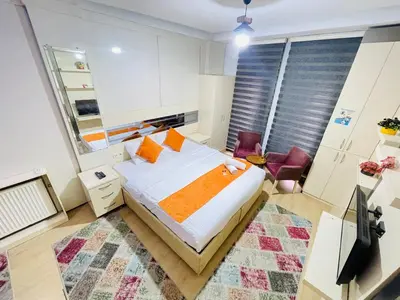 a bedroom with a bed with orange pillows at Taksim Gold House Hotel in Istanbul