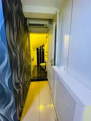 a hallway of a bathroom with a yellow wall at Taksim Gold House Hotel in Istanbul