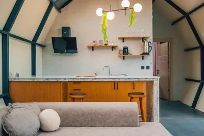 a living room with a kitchen and a couch at BALİ Sapanca in Sakarya