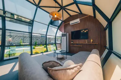 a living room with a couch and a large window at BALİ Sapanca in Sakarya